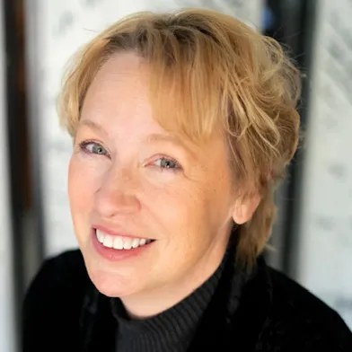 Lorilee Bajema, piano and voice teacher, smiling in a professional portrait